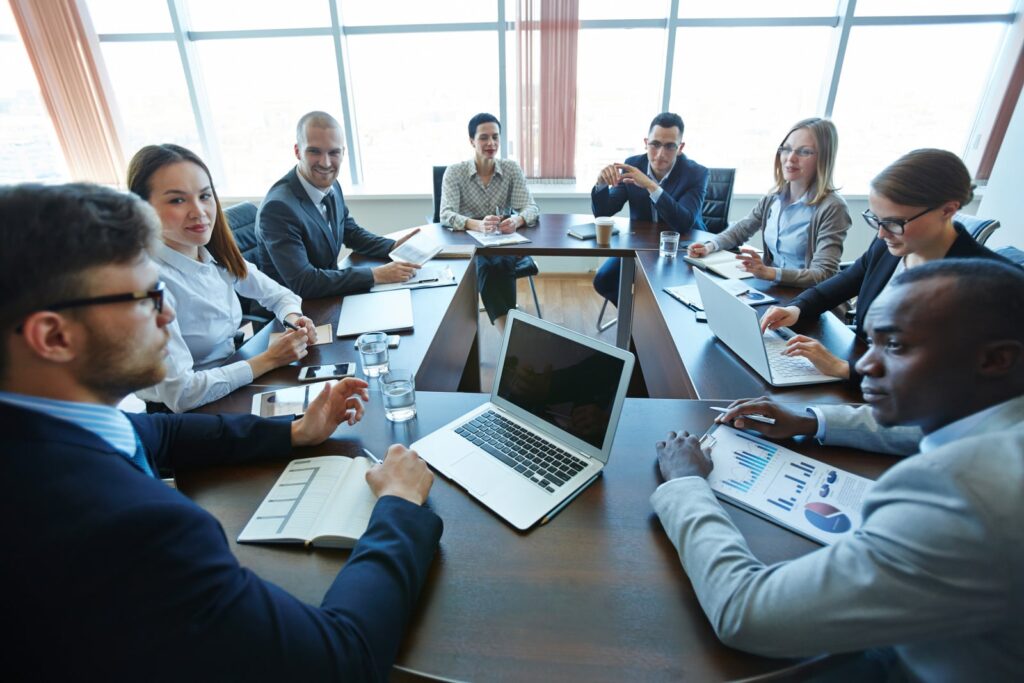 Business team collaborating during a meeting in a modern office space with charts.